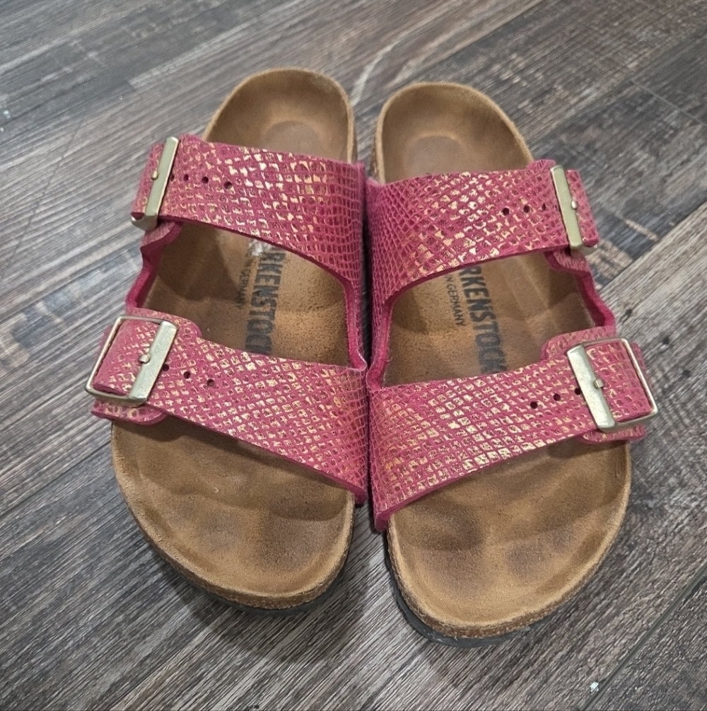 Birkenstock Arizona sandals in a fuchsia/pink embossed (snake or metalic)